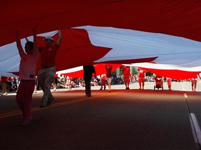 Flag bearers carry the giant Maple Leaf in Windsor's Canada Day parade of 2008.