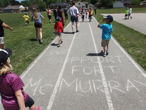 Students at St Gabriel Elementary School participate in a walk on Thursday, June 2, 2016, to support residents affected by the wildfires in Fort McMurray.