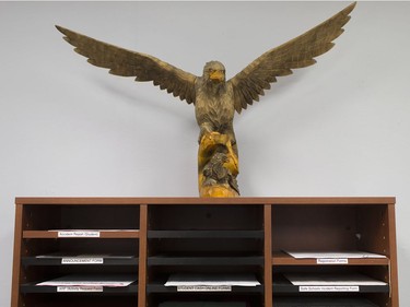 A wood carved hawk sits atop a filing cabinet in the main office at Harrow District High School, Thursday, June 16, 2016.  The school is to be closed for good after this school year.