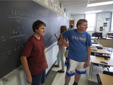 Chris Maag, 14, left, and Tim Sulja, 15, work out math exercises in Paul Gelinas' grade nine academic math class at Harrow District High School, Thursday, June 16, 2016.  The school is to be closed for good after this school year.