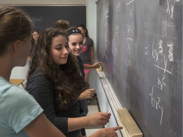From left, Ashley Brush, 15, Lexxus Adam, 14, and Shelby Robillard, 14, attend Paul Gelinas' Grade 9 academic math class at Harrow District High School, Thursday, June 16, 2016.  The school is to be closed for good after this school year.