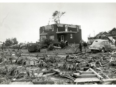 June 1946: A roofless house and two vehicles -- one flipped over and the other with its back window broken -- are shown in a undisclosed location following the tornado that swept through the Windsor area on June 17, 1946.