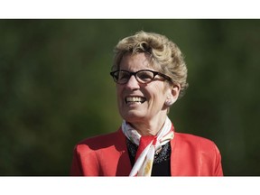 Ontario Premier Kathleen Wynne looks on before making a climate change policy announcement at Evergreen Brickworks in Toronto, Wednesday, June 8, 2016.