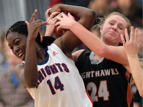 Holy Names Knights' Mildred Okoko battles Orillia Nighthawks' Charlotte Van Amelsvoort for the ball during their OFSAA AAA basketball game on Nov. 27, 2015, in Windsor, Ont.