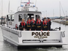 The Ontario Provincial Police introduced its newest marine vessel on Thursday, June 23, 2016, named after retired commissioner Chris D. Lewis. Lewis, second from left, and other ranking officers are shown during the event aboard the vessel.