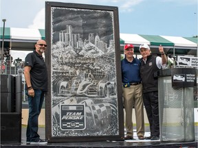 Tecumseh's Marc Lacourciere, left, gets a thumbs up for his artwork from Roger Penske, right, and Michigan Gov. Rick Snyder.