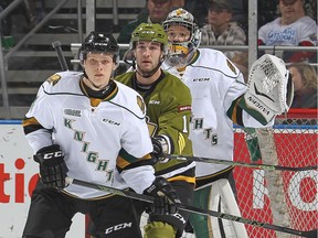 Mike Baird #11 of the North Bay Battalion is watched closely by Olli Juolevi #4 of the London Knights during an OHL game on Oct. 24, 2015 in London.