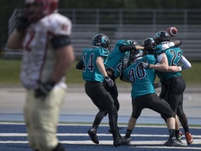 Members of the Essex Ravens celebrate after Chase Boycott intercepted a pass and returned it for a touchdown against the Niagara Spears at Alumni Field on June 5, 2016.