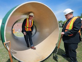 Mayor Drew Dilkens (L) and councillor Ed Sleiman check out the interior of a massive pipe as ENWIN held a ceremonial groundbreaking for a new water reservoir at the AH Weeks Water Treatment Plant in Windsor on Friday, June 10, 2016.