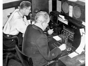 June 19, 1946: The telephone switchboard in the Windsor City Police radio room never before handled so many calls as it did after the tornado struck. Its seven trunk lines, incoming, were full all the time. Radio room dispatchers Robert "Bob" Morrison, right, and Elmer Horne take the calls. Dispatchers Wilbur "Curly" Wigle and Thomas Wigle and Thomas Clancy were on duty the night of the storm.