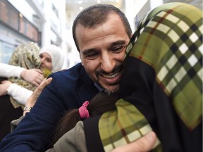 Salim Alaradi is greeted by family as he arrives at Pearson International Airport in Toronto, Monday, June 20, 2016.