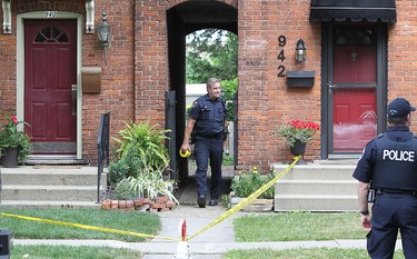 Windsor Police officers are shown at a townhouse in the 900 block of Monmouth Rd. on Wednesday, June 22, 2016, in Windsor, Ont. The investigation was related to a shooting at Wyandottte St. E. and Walker.