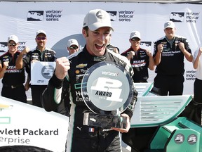 Simon Pagenaud celebrates after winning the pole position in qualifications for Race 1 of the IndyCar Detroit Grand Prix auto racing doubleheader on Belle Isle in Detroit, Friday, June 3, 2016.