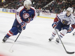 Windsor's Christian Fischer, left, is defended by Hamilton's Jack Hidi in OHL action between the Windsor Spitfires and the Hamilton Bulldogs at the WFCU Centre on Feb. 21, 2016.