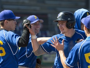 St. Anne's Mitchell Zimmerman celebrates with teammates after scoring a run early in their OFSAA boys' championship baseball game against Bishop Allen at Labatt Memorial Park in London, Ont. on June 8, 2016.