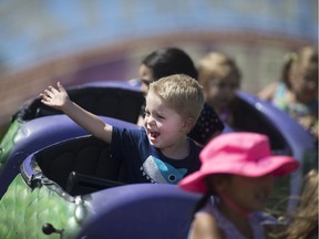 Owen Shaw, 4, waves to his parents while riding the Dragon Wagon at the LaSalle Strawberry Festival, Sunday, June 12, 2016.