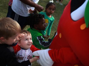Gavin McCullough, 2, center, joins a group of kids saying hi to Captain Strawberry at the LaSalle Strawberry Festival in this 2012 file photo.