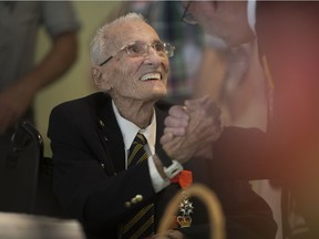 Second World War veteran, Real Joseph DeGuire, left, is greeted by Ian Spencer, a retired Royal Marine from England, at the Riverside Sportsmen Club, Sunday, June 5, 2016.  DeGuire received the Ushakov medal from Russian president, Vladimir Putin, for being in the arctic circle during the Second World War.