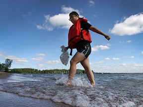 Jenny Tan, a public health inspector with the Windsor-Essex County Health Unit is shown collecting water samples at the Sandpoint Beach in Windsor, Ont. on Wednesday, June 8, 2016. The organization has started the seasonal water quality testing at 10 local beaches.