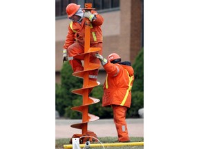 In this file photo, Enwin Hydro workers install new hydro poles along Park Street West in Windsor on Monday Dec. 15, 2008. (photo: Chris Kornacki)
