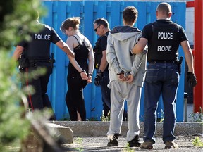 Two people are taken into custody following a police raid on a home on Henry Ford Centre Drive in Windsor on Thursday, June 23, 2016.  One man was arrested in connection with the shooting in Walkerville.