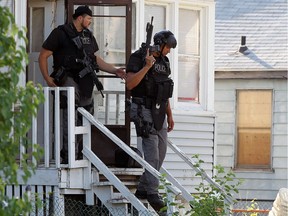 Windsor police Emergency Response Team members leave a house following a raid on a home on Henry Ford Centre Drive in Windsor on Thursday, June 23, 2016.