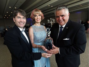 Matt Marchand, left, and Janice Forsyth present Peter Hrastovec with a lifetime achievement award at the Windsor-Essex Regional Chamber of Commerce gala at the St. Clair Centre for the Arts in Windsor on Friday, June 24, 2016.