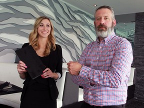 Fourteen GM and designer Steve Brough, right, and Kristen Makaric prepare to greet customers June 9, 2016.  Fourteen, a new restaurant, is located on the 14th floor of the CIBC building at Ouellette Avenue and Riverside Drive East.