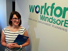 Heather Gregg, manager of employer engagement, stands next to the new Workforce WindsorEssex logo on June 10, 2016.