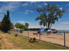 Windsor, Ontario. June 13, 2016. Motorists and pedestrians now have a clear view of Sand Point beach and Lake St. Clair.  Dark green fence inserts have been removed from the north side fence along Riverside Drive East. (NICK BRANCACCIO/Windsor Star)