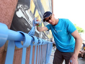Don Livermore a master blender with Hiram Walker & Sons Ltd. takes time out from his job to help spruce up a park on Drouillard Road in Windsor, Ontario on June 2, 2016.