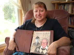 Sandy Ozarak holds a photo of her late father, Howard Pastrick, 85, who died Jan. 15. Ozarak says a new program — overnight personal support workers connected by computer to an RN — helped her father stay at home in his final days rather than going to a hospital.