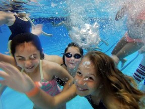 Students from St. Anne French Immersion Catholic Elementary School swim under water in the WorldÕs Largest Swimming Lesson at the Windsor International Aquatic and Training Centre in Windsor, Ontario on June 24, 2016.