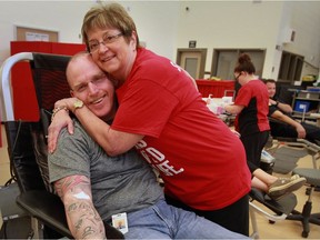 Corrections officer Andrew Montgomery gets a heartfelt hug from Janice Powell during Canadian Blood Services Sirens For Life Blood Challenge held at South West Detention Centre on June 29, 2016.