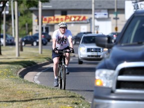 Windsor mayor Drew Dilkens rides his bike to work down Ouellette Avenue on June 30, 2016.