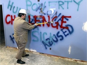 Ron Dunn, executive director of the  Downtown Mission, hits a wall to officially kick off the fundraising campaign for the new wellness centre.