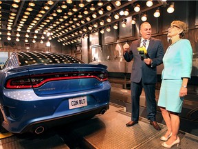 Premier Kathleen Wynne held a media conference on Wednesday, June 15, 2016, at the University of Windsor-Fiat Chrysler Automotive Research and Development Centre to announce support for the first plug-in hybrid electric minivan to be built in North America. The province will provide $85.8 million to FCA to develop the Chrysler Pacifica Hybrid. Wynne is shown during the event with Tony Mancina, director of Canada engineering at the centre who was demonstrating a climate testing station.