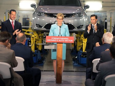 WINDSOR, ON. JUNE 15, 2016 - Premier Kathleen Wynne held a media conference on Wednesday, June 15, 2016, at the University of Windsor-Fiat Chrysler Automotive Research and Development Centre to announce support for the first plug-in hybrid electric minivan to be built in North America. The province will provide $85.8 million to FCA to develop the Chrysler Pacifica Hybrid. Wynne is shown with Reid Bigland (L), president and CEO, FCA Canada, Brad Duguid, Minister of economic development and growth and Alan Wildeman, president & vice-chancellor of the University of Windsor. (DAN JANISSE/The Windsor Star) (For story by Grace Macaluso)