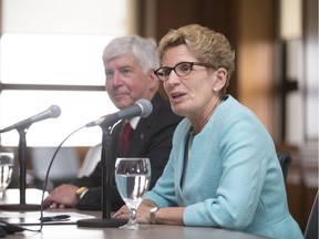 Ontario Premier, Kathleen Wynne, holds a press conference with Michigan Governor, Rick Snyder, left, in the Cadillac Building in Detroit, Mich., Wednesday, June 15, 2016.