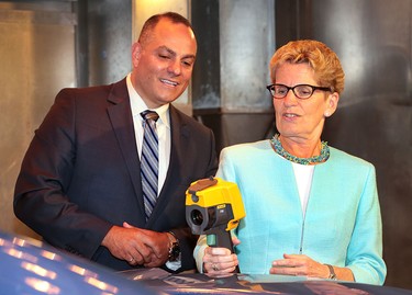 Premier Kathleen Wynne held a media conference on Wednesday, June 15, 2016, at the University of Windsor-Fiat Chrysler Automotive Research and Development Centre to announce support for the first plug-in hybrid electric minivan to be built in North America. The province will provide $85.8 million to FCA to develop the Chrysler Pacifica Hybrid. Wynne is shown during the event with Tony Mancina,  director of Canada engineering at the centre who was demonstrating a climate testing station.