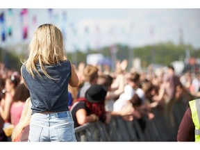 It's summertime! Young woman at outdoor music festival in summer. Photo by Getty Images.