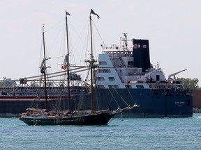 Tall ship S V Denis Sullivan passes lake freighter Algoma Olympic on Detroit River Tuesday July 12, 2016.