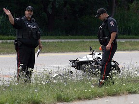 Windsor police investigate a motorcycle collision on Ojibway Parkway that sent a motorcyclist to hospital with serious injuries on July 15, 2016. (Tyler Brownbridge/Windsor Star)