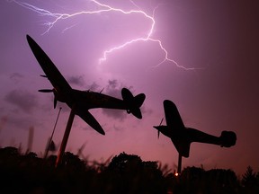 Lightning explodes across the sky as the Spitfire and Hurricane replica planes are silhouetted at Jackson Park in Windsor, Ont. in this 2011 file photo. (JASON KRYK/The Windsor Star)