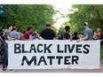 A Black Lives Matter rally is held at Bronson Park on Friday, July 22, 2016 in Kalamazoo, Mich. After the rally at Bronson Park, the movement preceded to shut down the Kalamazoo Mall by blocking the street and demanding change from Kalamazoo government officials and Kalamazoo Public Safety. (Bryan Bennett/Kalamazoo Gazette-MLive Media Group via AP)