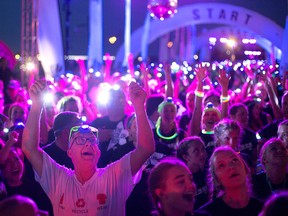 People take part in The Color Run Night 5k along Windsor's waterfront Saturday evening, July 23, 2016.