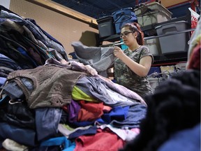 The Community Thrift Store is one of Windsor's newest and largest second-hand stores. It runs as a business and donates to local charities. Emily Ackle, 18, a store employee sorts through donated clothing on Tuesday, July 5, 2016.