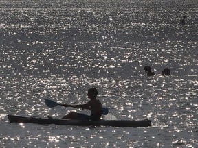 People cool down in the water off the west Belle River beach on another scorching hot day on Wednesday, July 13, 2016.