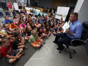 Devin Scillian, news anchor at WDIV-TV in Detroit, reads to summer class at the Catholic Education Centre in Windsor on Thursday, July 21, 2016. Scillian, who has published 16 books, read to students from his book Memoirs of a Goldfish.