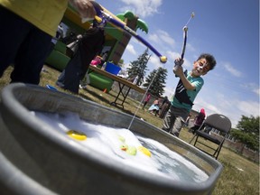 Abdul Hamid, 6, casts his line into a tub of soapy water at the 2016 Eid Festival at the Rose City Islamic Centre, Saturday, July 9, 2016.